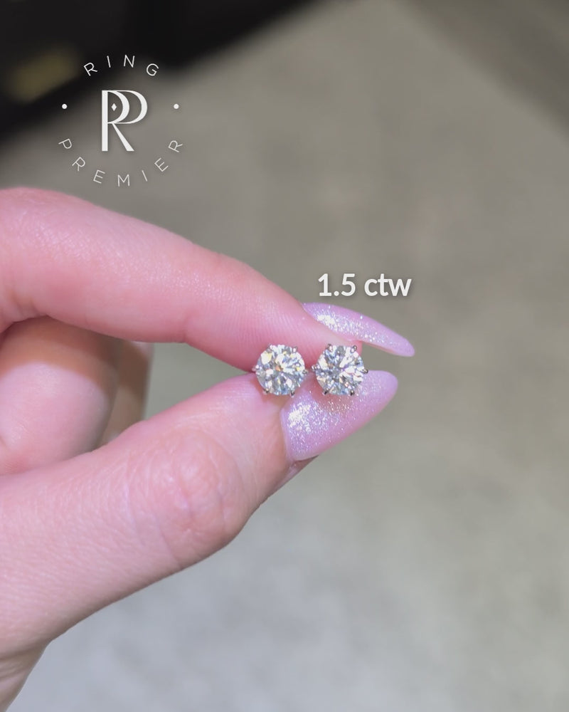 Vienna 1.5 carat (1.5 ct tw) round lab-grown diamond stud earrings in a white gold 6-prong crown setting, shown held in hand