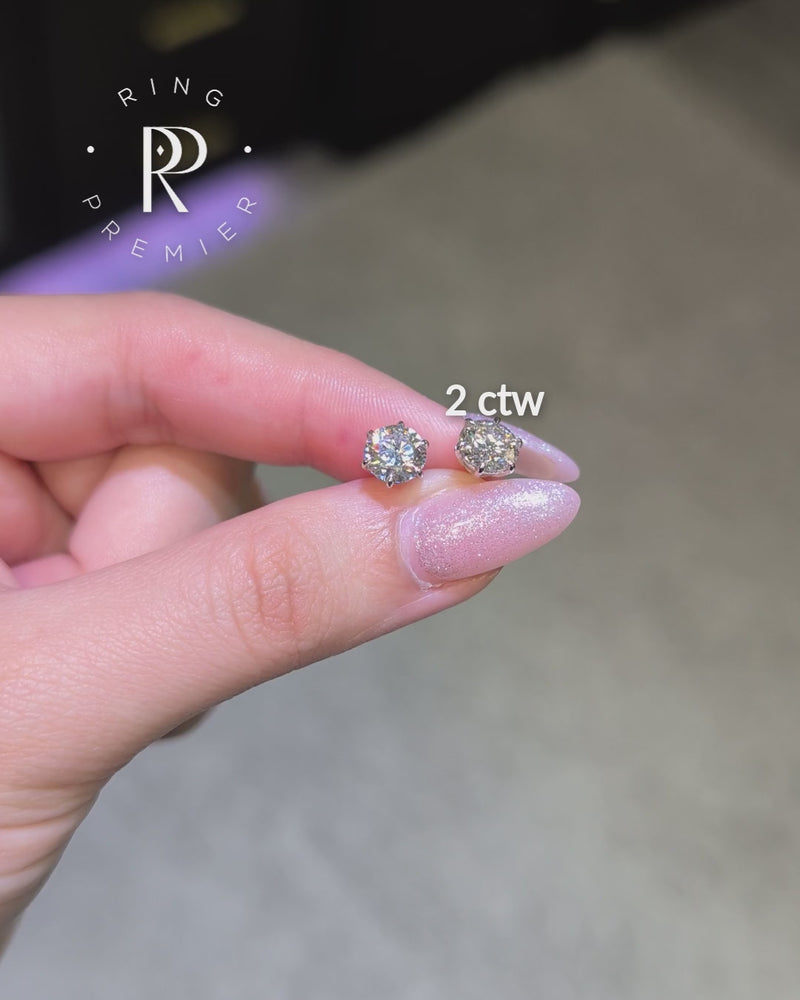 Vienna 2 carat (2 ct tw) round lab-grown diamond stud earrings in a white gold 6-prong crown setting, shown held in hand