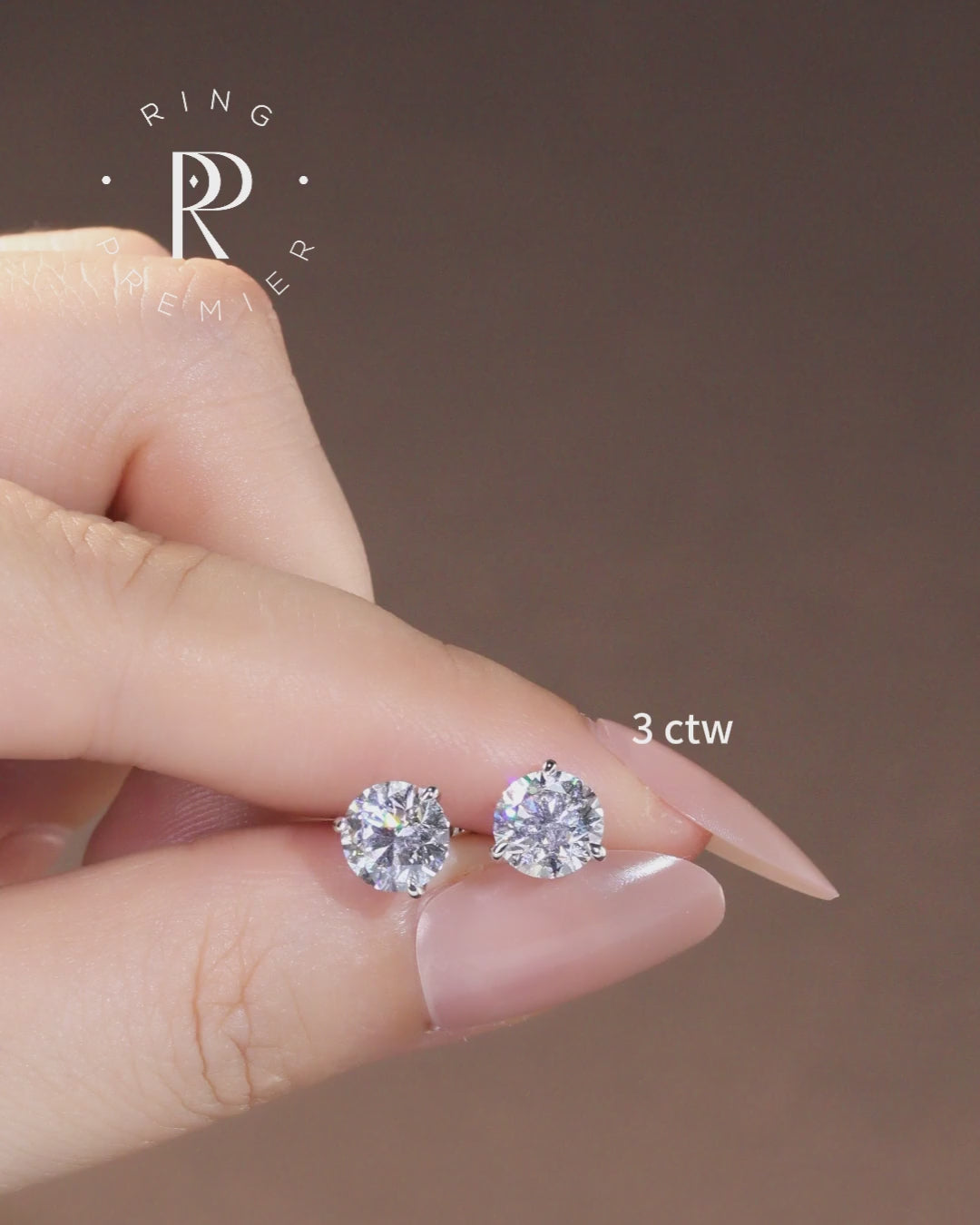 Florence 3 carat (3 ct tw) round lab-grown diamond stud earrings in a 3-prong martini setting, shown held in hand