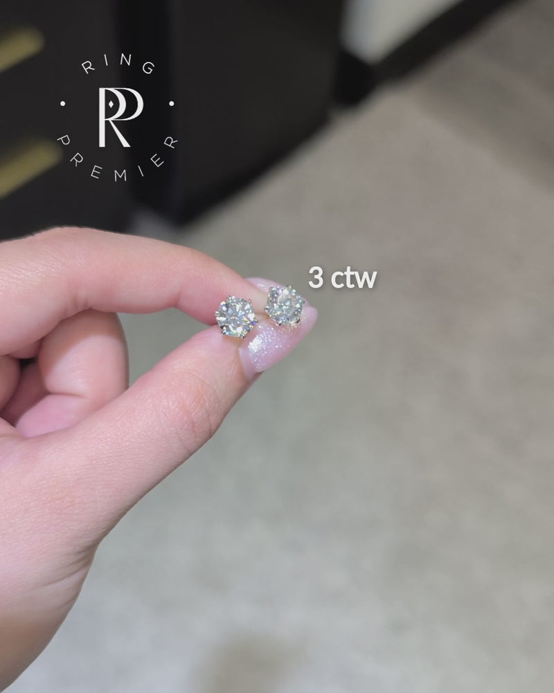Vienna 3 carat (3 ct tw) round lab-grown diamond stud earrings in a white gold 6-prong crown setting, shown held in hand