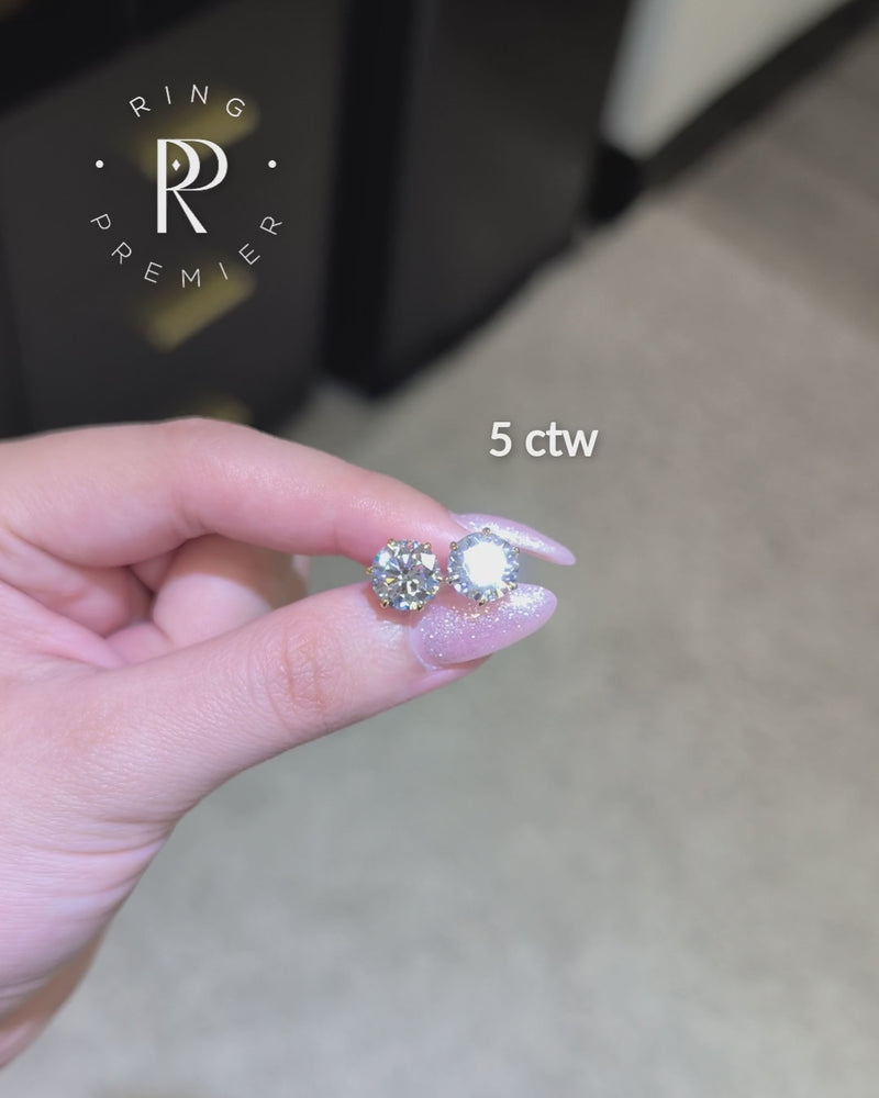Vienna 5 carat (5 ct tw) round lab-grown diamond stud earrings in a yellow gold 6-prong crown setting, shown held in hand