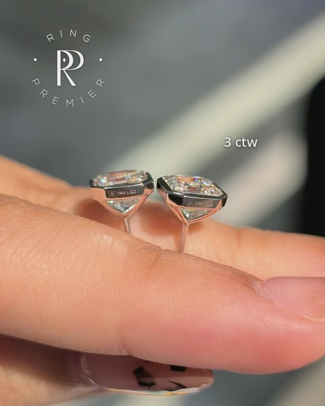 Bezel Set Martini Asscher 3 carat (3 ct tw) lab-grown diamond stud earrings in white gold, shown held in hand with side profile of the martini setting