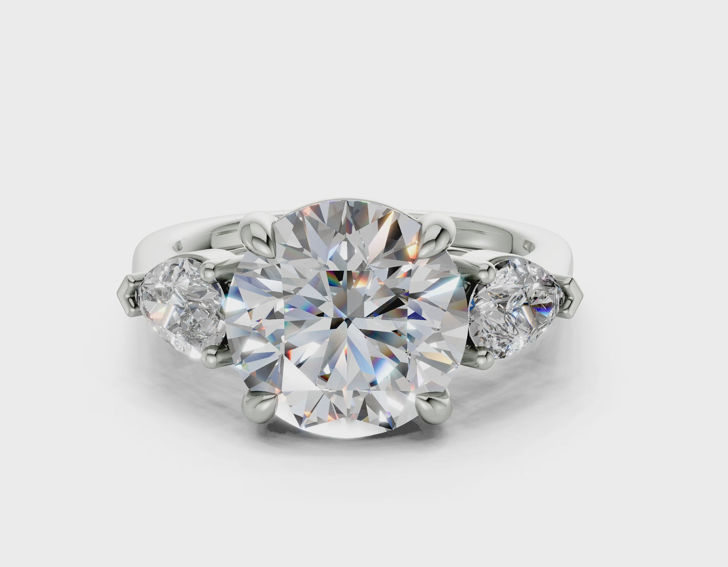 The Vara Three-Stone — 5.00ct Round E VS1  with Pear Side Stones